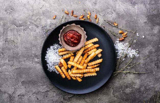 French potatoes on dark plate