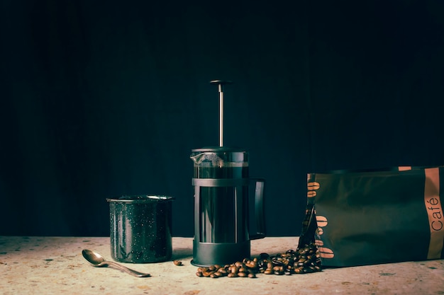 French press, coffee beans and cup