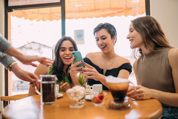 フレンチプレスコーヒー。ブラジルのカフェショップのテーブルでコーヒーを待っている友達。