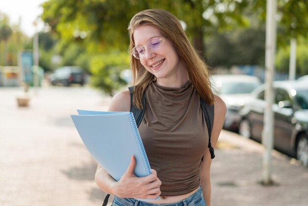 French student french girl with glasses at outdoors with happy expression