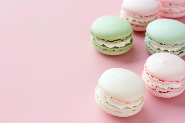 French sweet macaroons in soft colors on light pink backdrop
