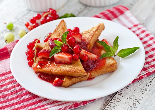 French toast with berries and jam for breakfast