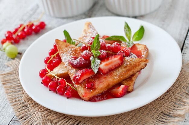 French toast with berries and jam for breakfast