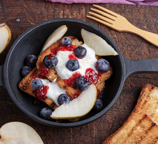 French toast with berries, syrup and sour cream 