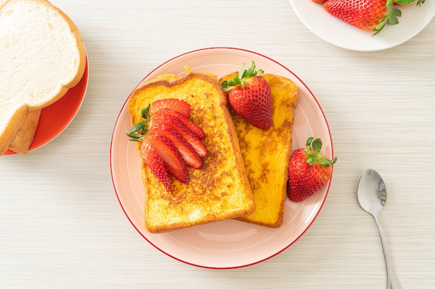 french toast with fresh strawberry on plate