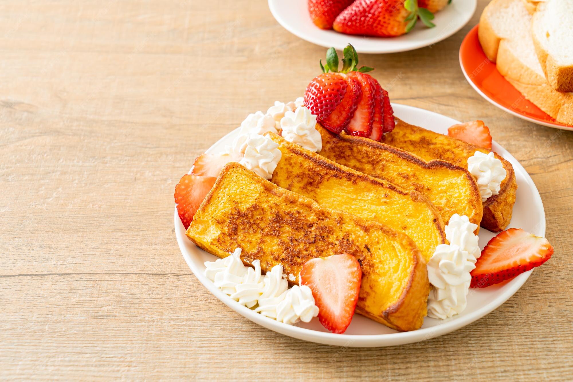 Premium Photo French toast with fresh strawberry and whipping cream