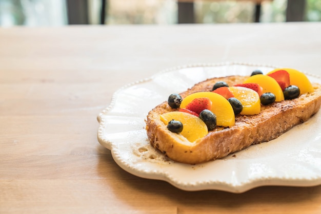 french toast with peach, strawberry and blueberries