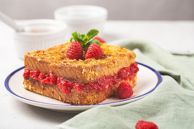 French toast with raspberry on a plate