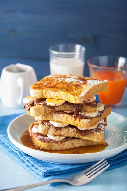 French toasts with banana chocolate sauce and caramel for breakfast