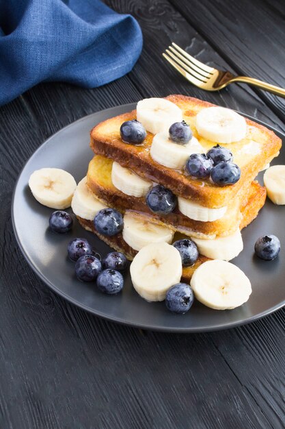 French toasts with blueberries, banana and honey