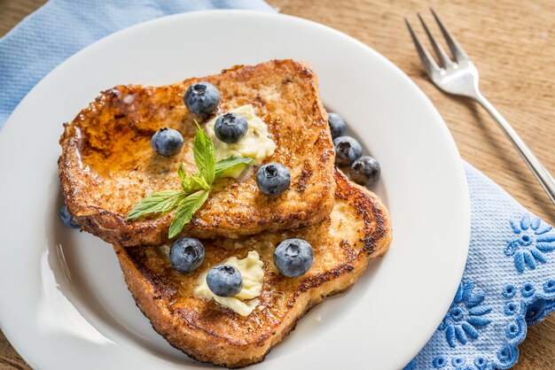 French toasts with fresh blueberries and maple syrup