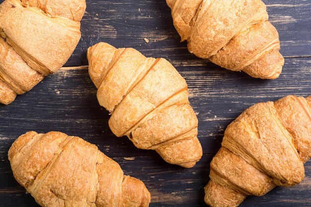 French traditional breakfast croissant on wooden background