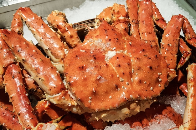 Fresh Alaska or Red king crab on Ice in Fish Market.