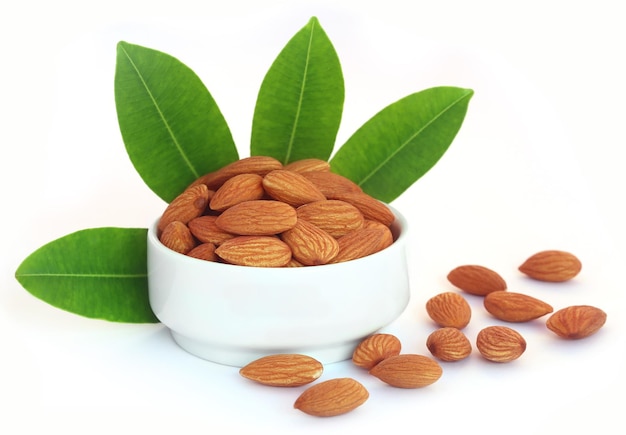 Fresh almonds in a bowl over white background