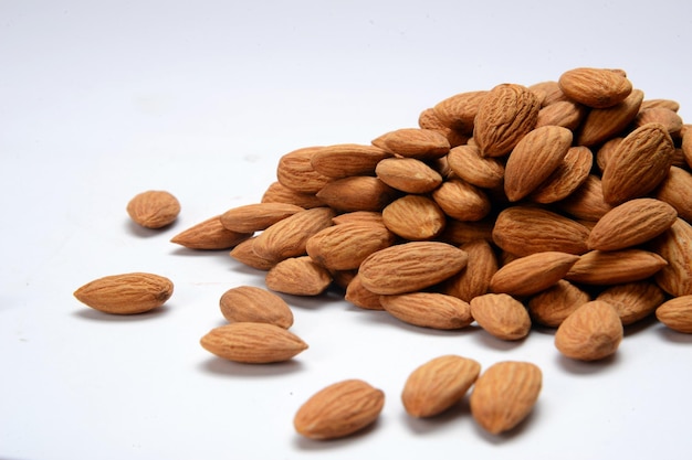 Fresh almonds in the wooden bowl, Organic almonds, almonds border white background.