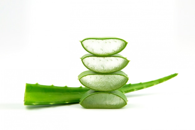 Photo fresh aloe vera leaves and slices is isolated with white background.