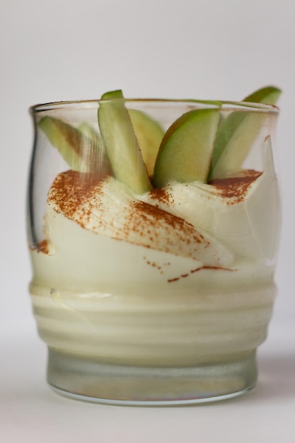 Fresh apple dessert with cinnamon and cream