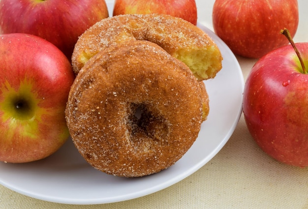 Fresh apple donuts with red apples