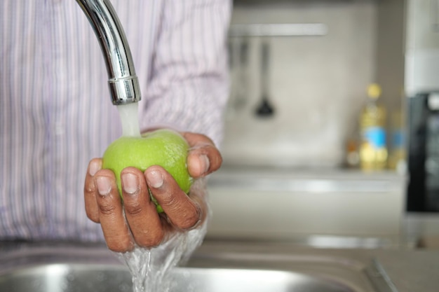 Fresh apple washing with hand