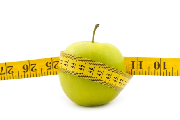 Fresh apple with measuring tape