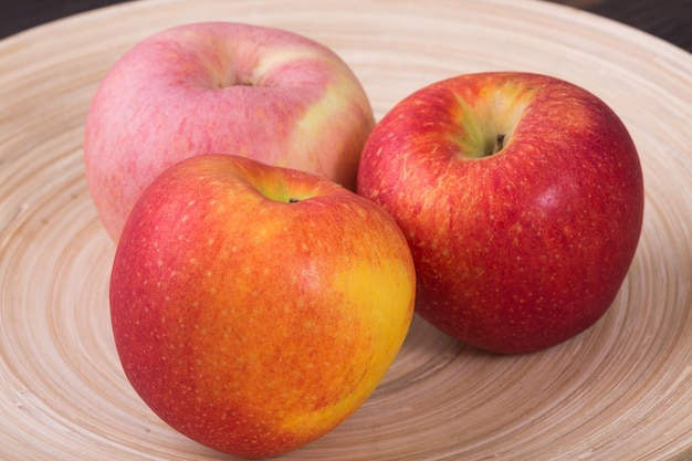 fresh apple in wooden bowl close up