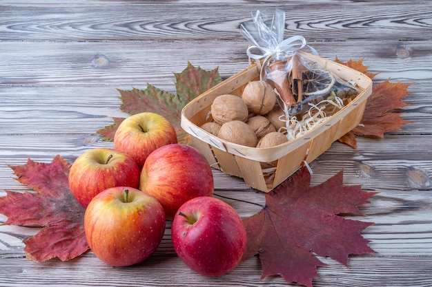 Fresh apples on the background of maple leaves fruit on the background antique wooden background