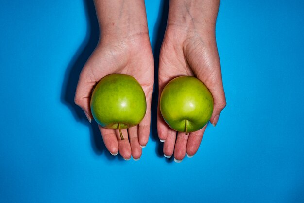 Fresh apples on blue background