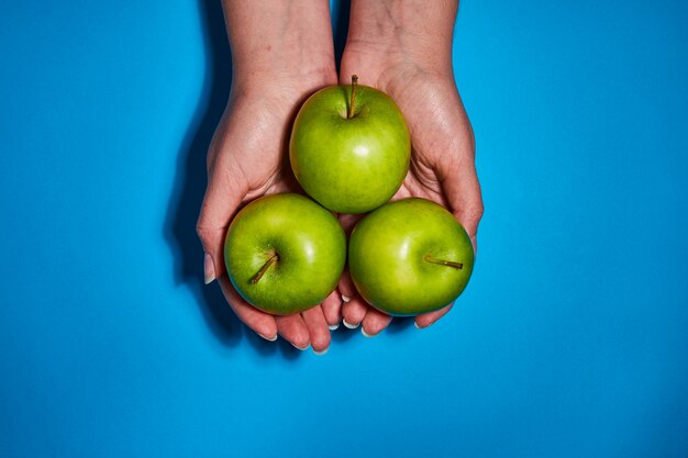 Fresh apples on blue background