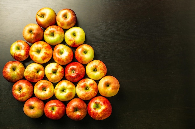 Fresh apples on a dark wooden background