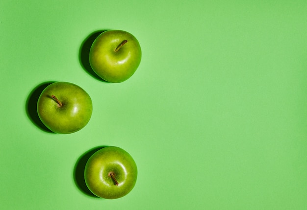 Fresh apples on green background