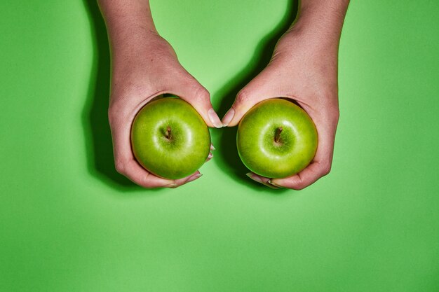 Fresh apples on green background