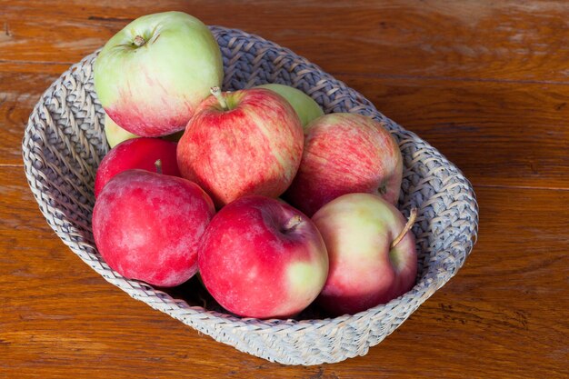 Fresh apples in straw basket