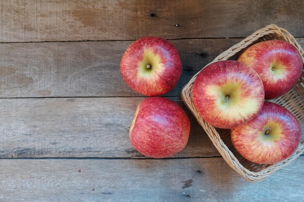 Fresh Apples  in wicker basket on old wood with copy space