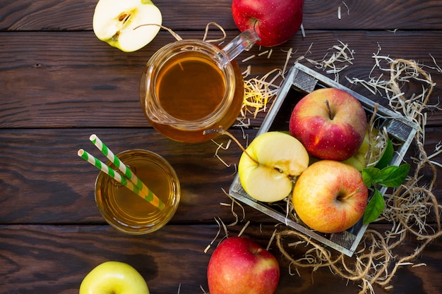 Fresh apples in a wooden box and juice