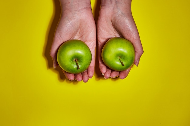 Fresh apples on yellow background