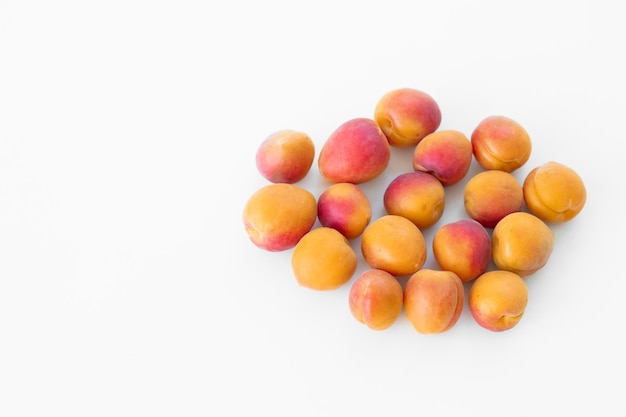 Fresh apricot fruit in closeup on white background