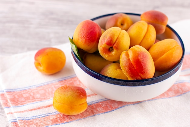 Fresh apricot on white wooden table