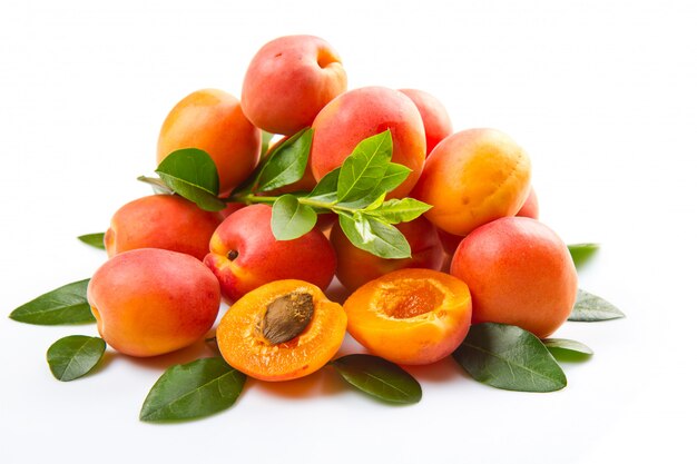 fresh apricots with leaf on white