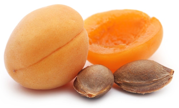 Fresh apricots with seed over white background