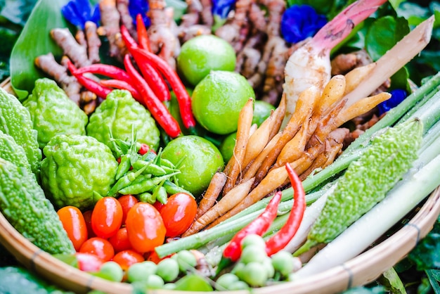 Foto erbe asiatiche fresche e ingredienti piccanti cibo in cesto di bambù