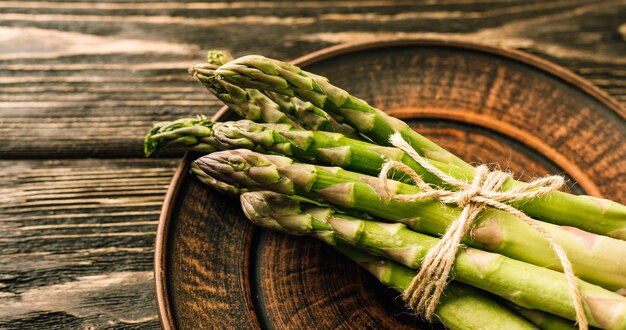 Fresh asparagus on a brown plate