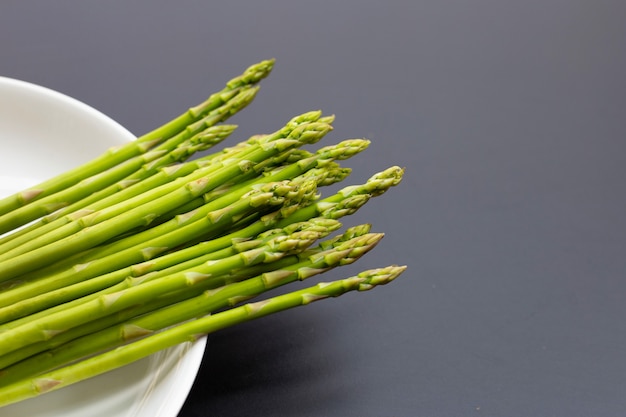 Fresh asparagus on dark background. Copy space