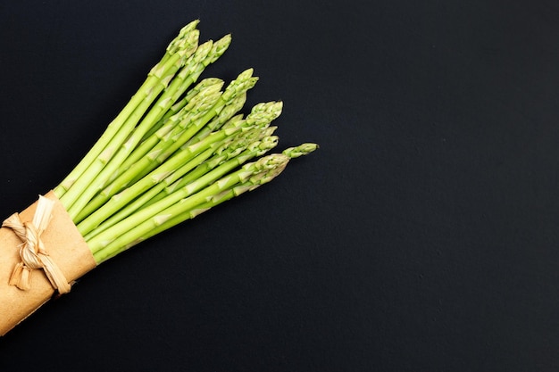 Fresh asparagus on dark background