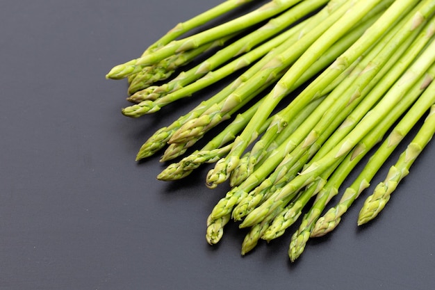 Fresh asparagus on dark background