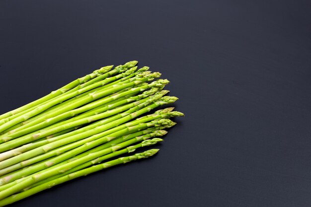 Fresh asparagus on dark surface