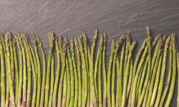 Fresh asparagus on a rustic slate background