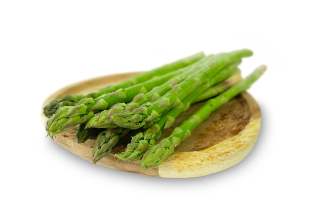 Fresh asparagus on a wooden board isolated on a white background