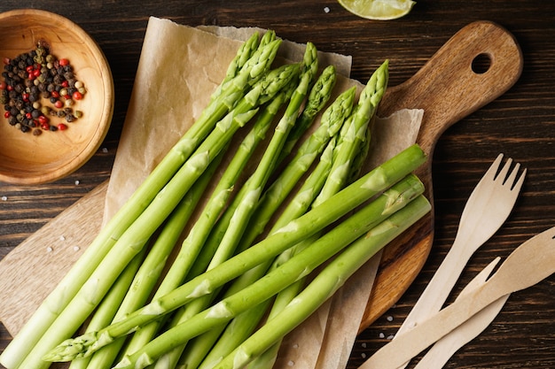 Fresh asparagus on wooden surface, close-up. Top view