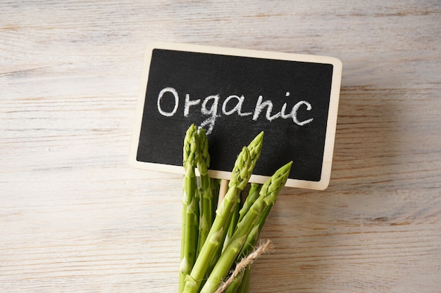 Fresh asparagus on wooden surface Close-up.