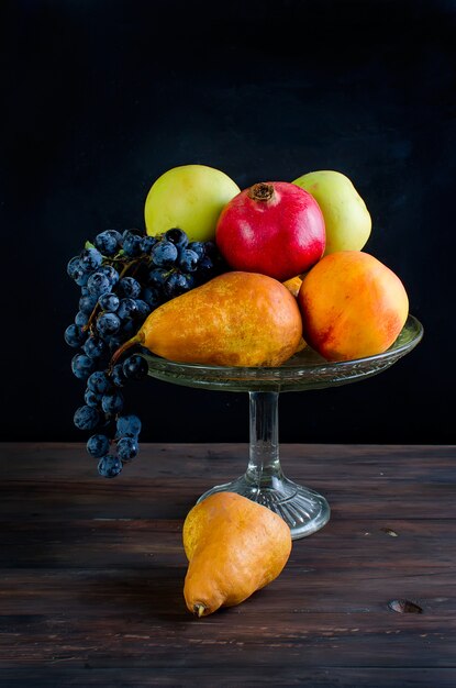 Fresh autumn fruits - pomegranate, pears, grapes and apples